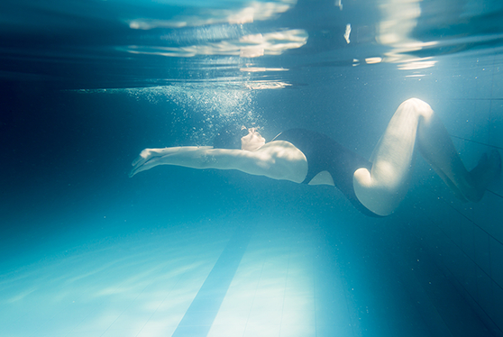 woman swimming under water